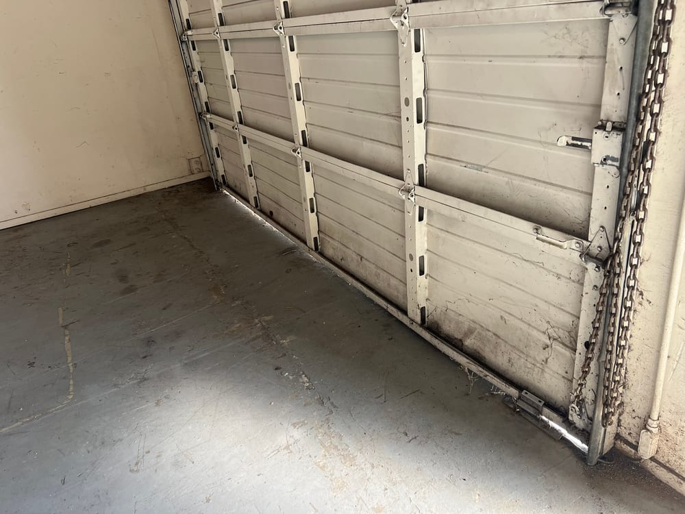 Inside of a sectional garage door showing hinges, rollers and the track