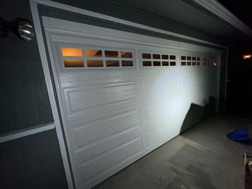 White raised-panel garage door on a single-car opening