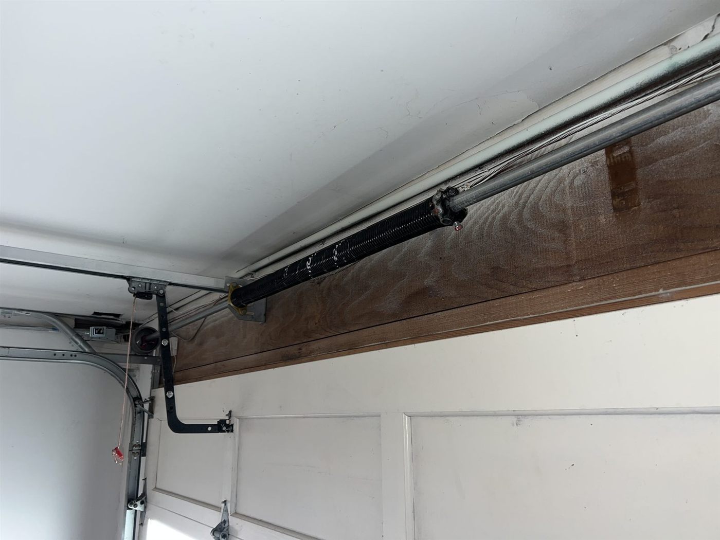 Newly fitted torsion spring on a residential garage door